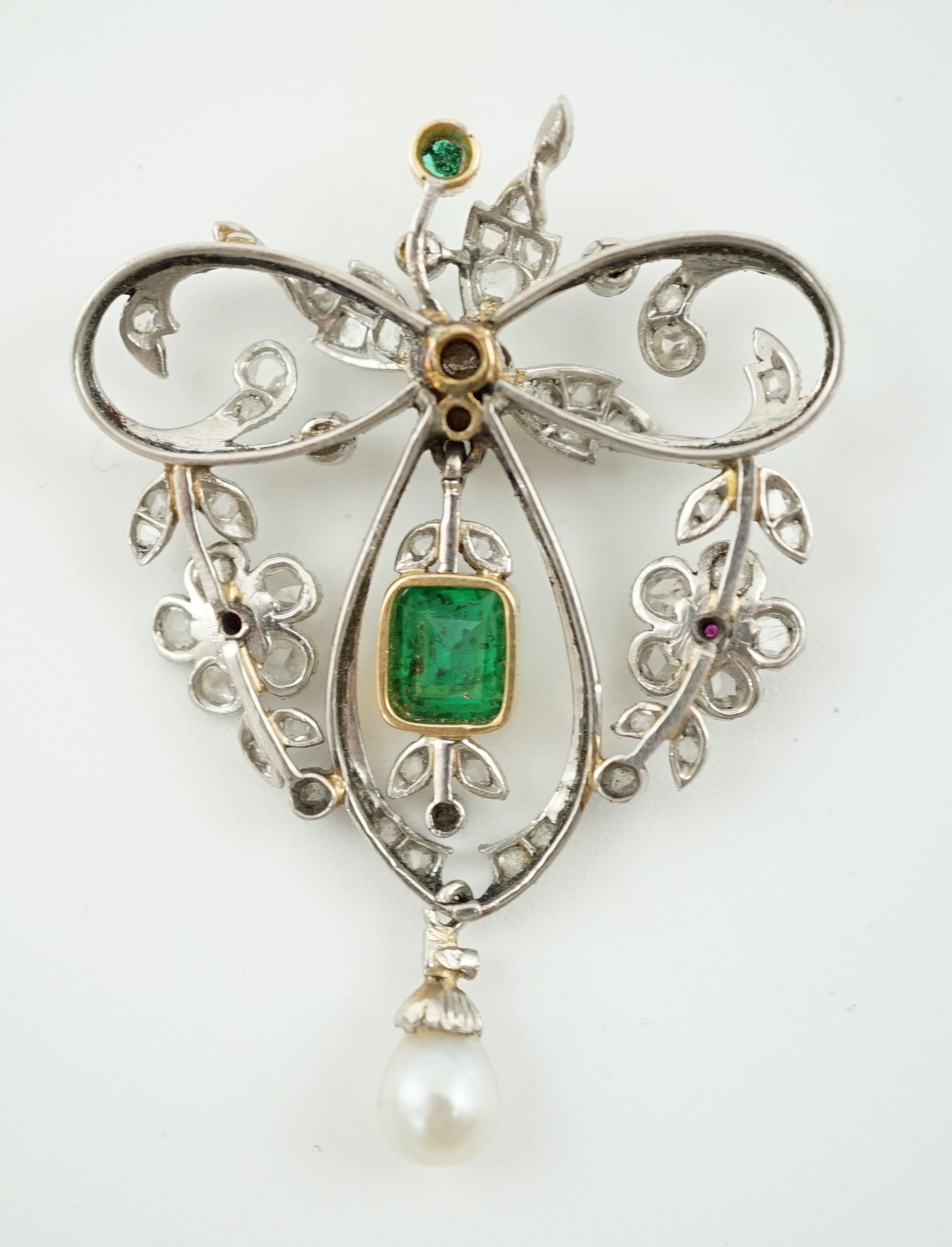 A Belle Epoque gold and platinum, emerald, pearl, ruby and diamond cluster set drop pendant brooch